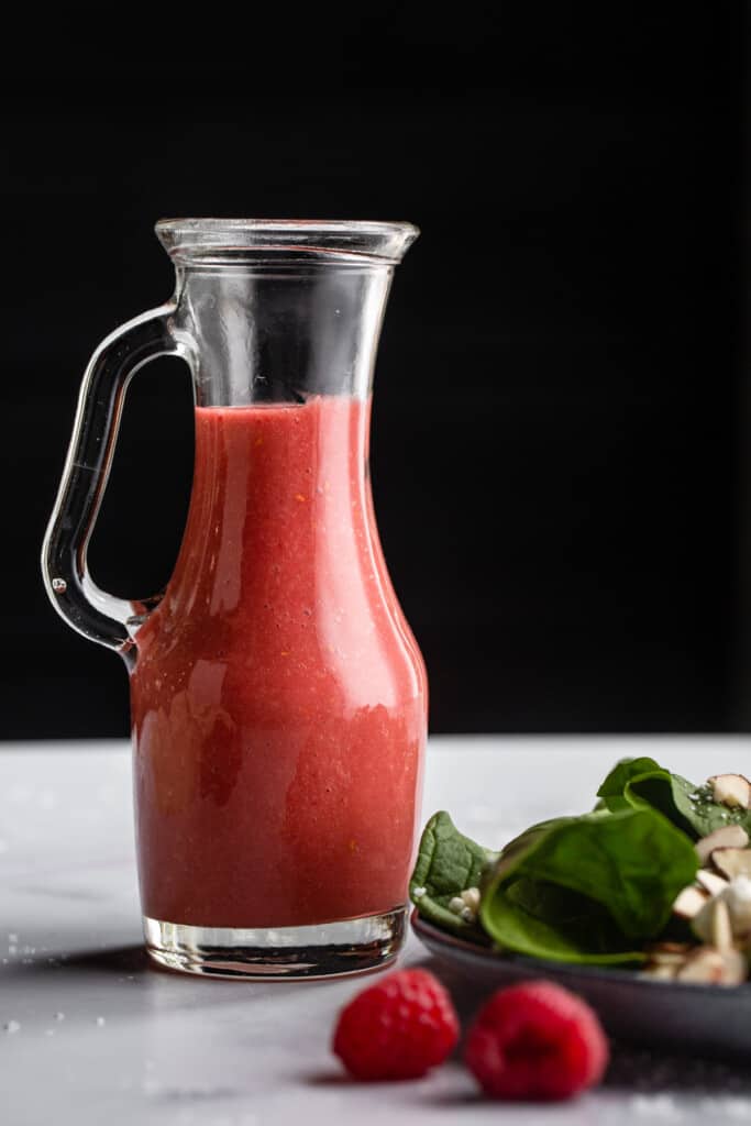 a pitcher filled with Raspberry Vinaigrette