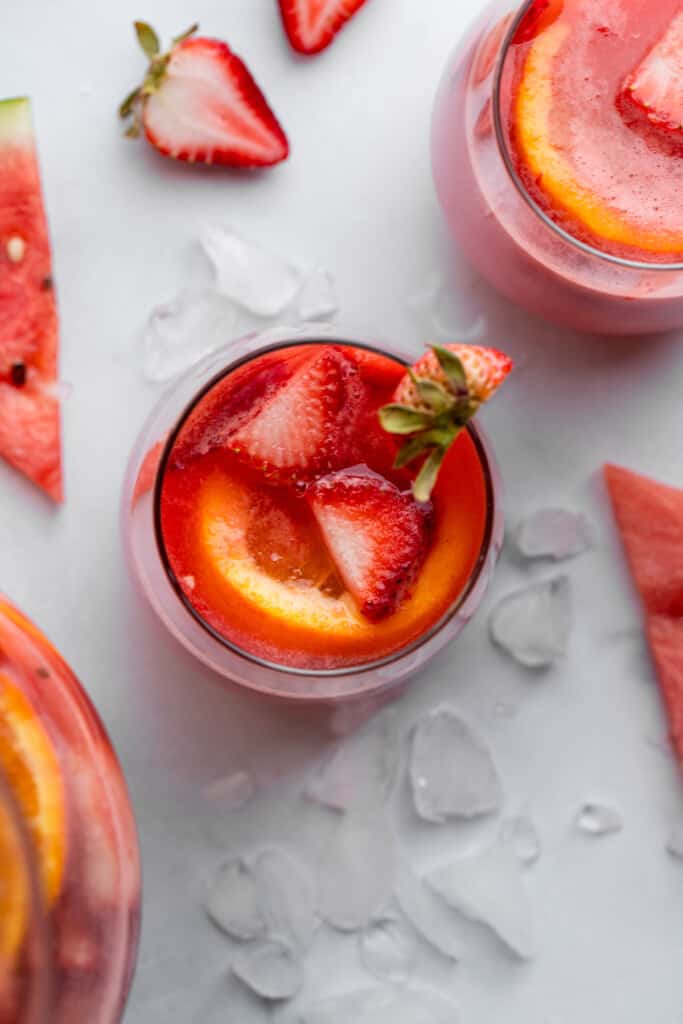 a glass of Watermelon Sangria with a strawberry garnish