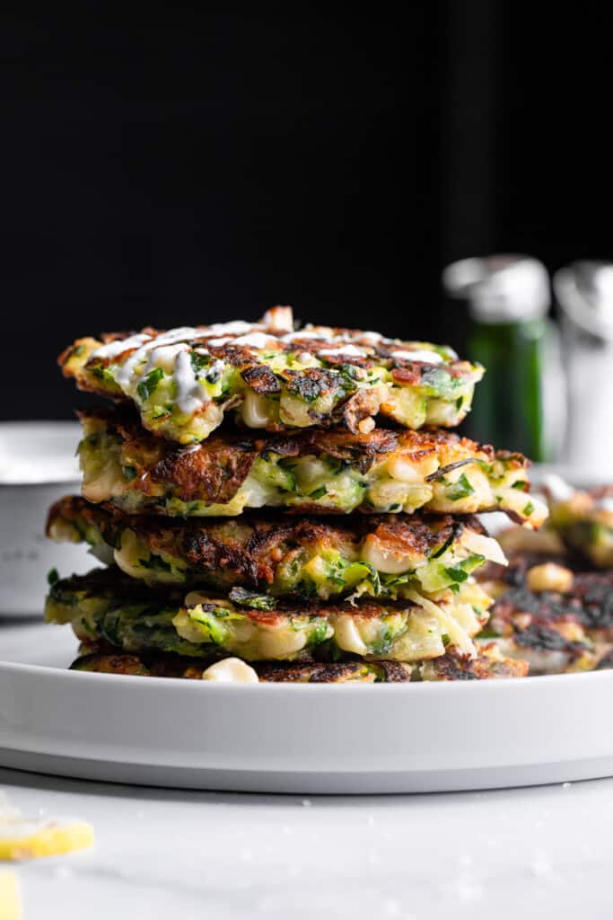 a stack of Zucchini Corn Fritters on a plate