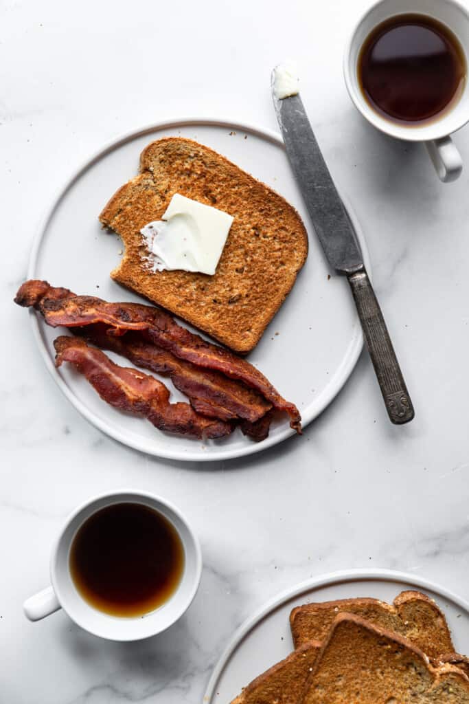 Air Fryer Toast on a plate with bacon and coffee