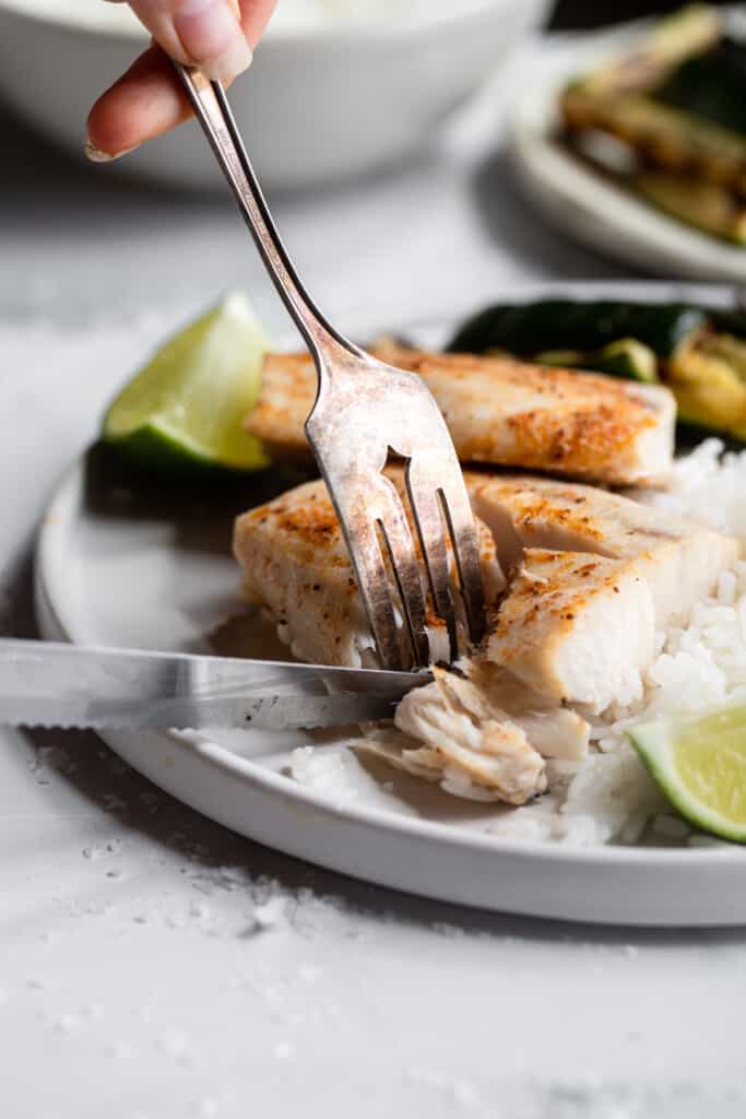a fillet of Air Fryer Mahi Mahi on a plate with fork and knife