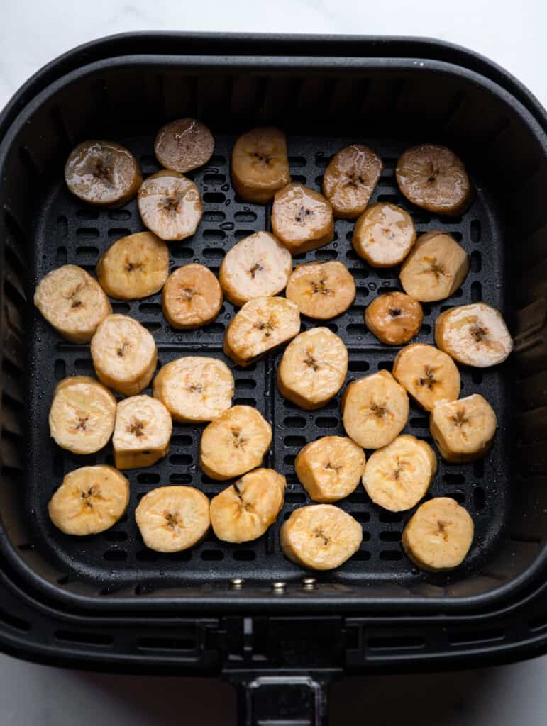sliced Air Fryer Plantains arranged in an air fryer