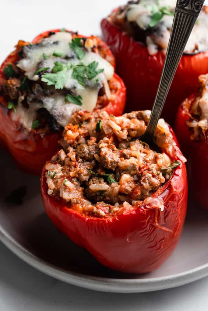 an Air Fryer Stuffed Peppers on a sheet with a spoon in it