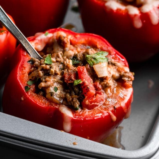 a Keto Stuffed Peppers in a baking dish with a fork inserted