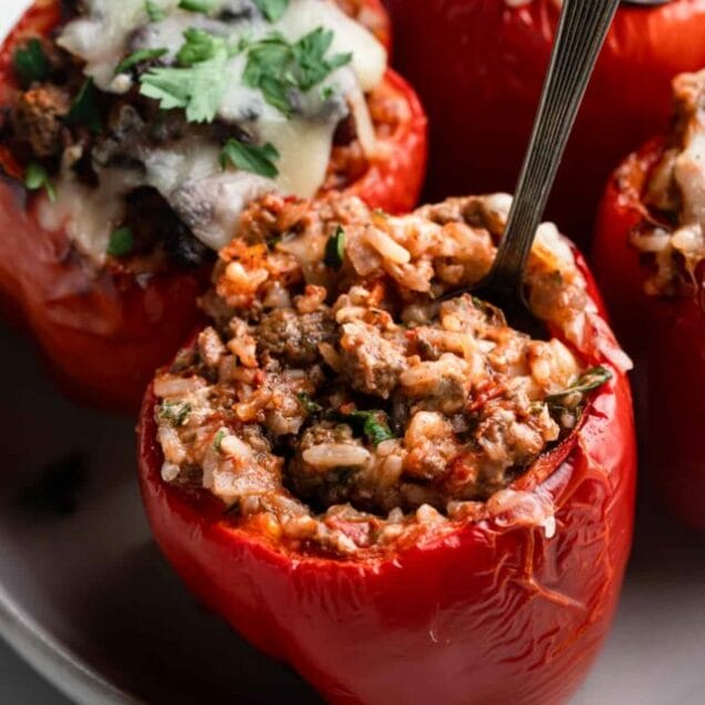 an Air Fryer Stuffed Peppers on a sheet with a spoon in it