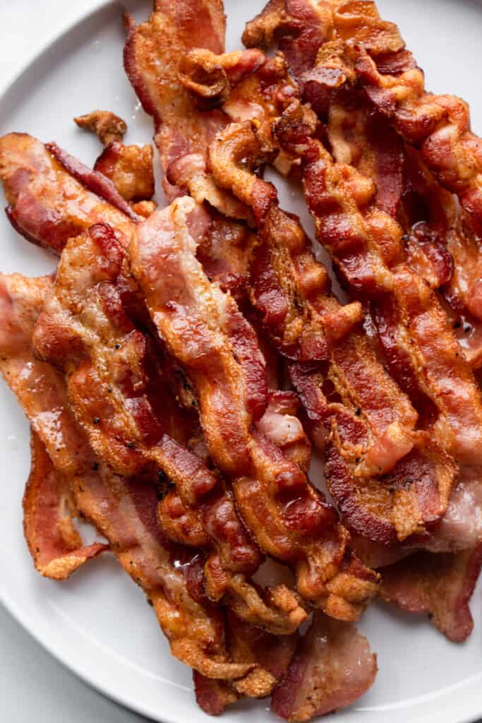 a large pile of air fryer bacon on a plate