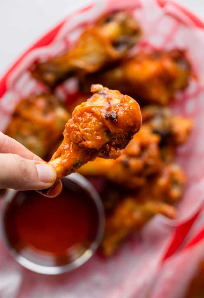one Air Fryer Chicken Wing being held up by hand