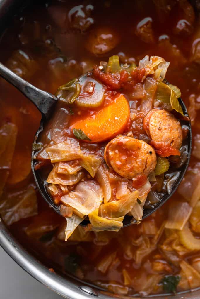 a large pot full of Cabbage Soup with Sausage