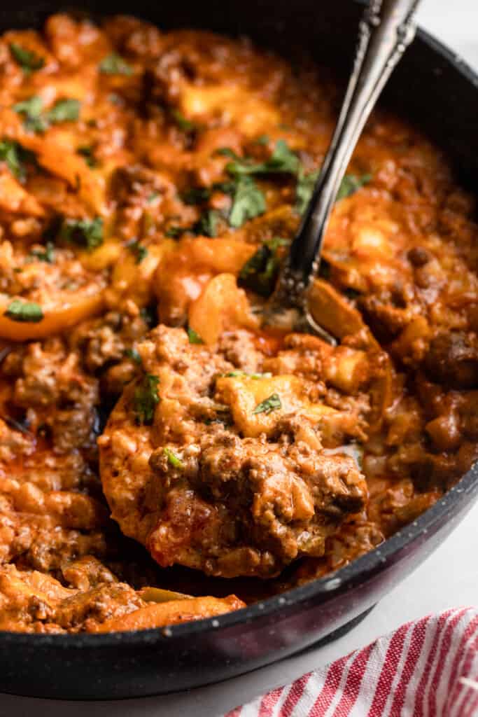 Keto Ground Beef Casserole in a pot with a large spoon