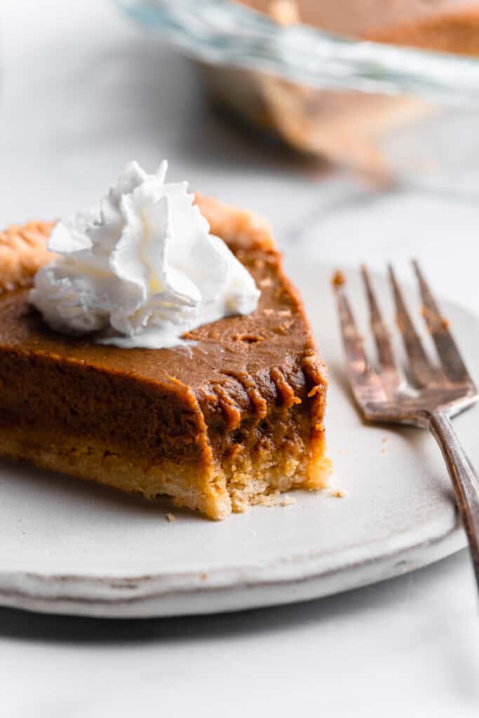 a slice of Paleo Pumpkin Pie with a bite missing