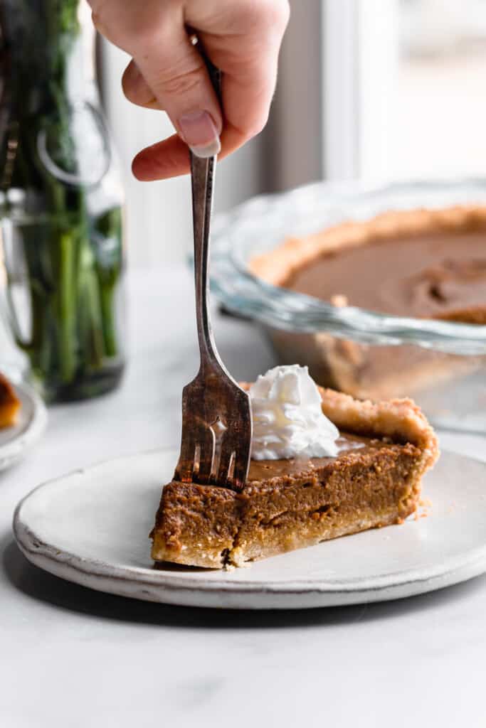 a slice of Paleo Pumpkin Pie being cut with a fork