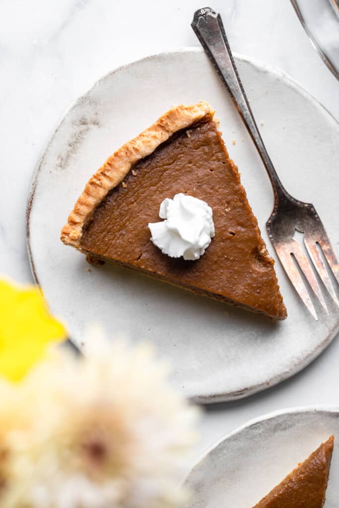 one slice of Paleo Pumpkin Pie on a small plate with a fork