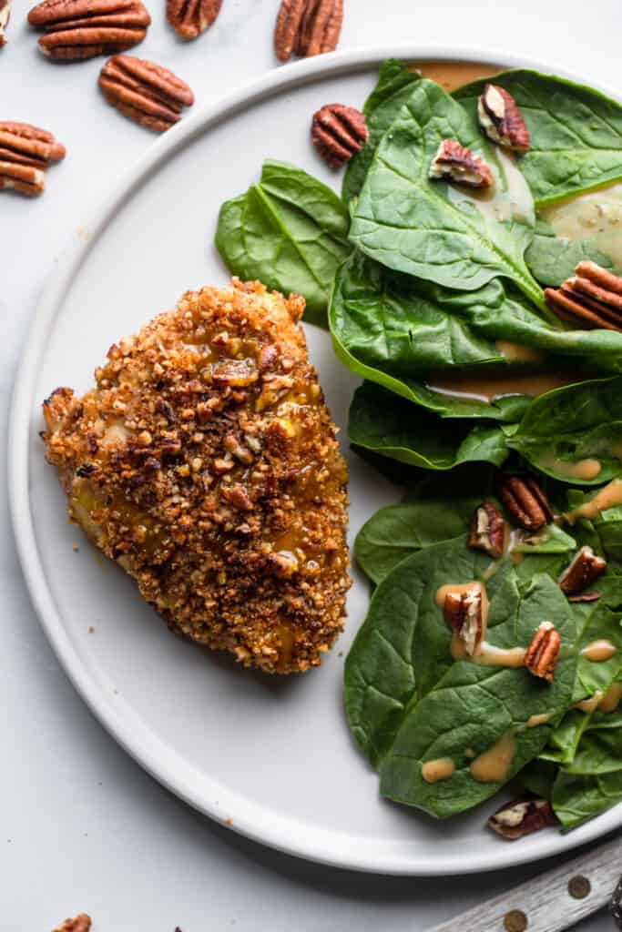 Pecan Crusted Chicken on a plate with a side of salad