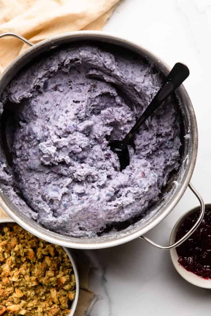 large pot full of Purple Mashed Potatoes with a serving spoon