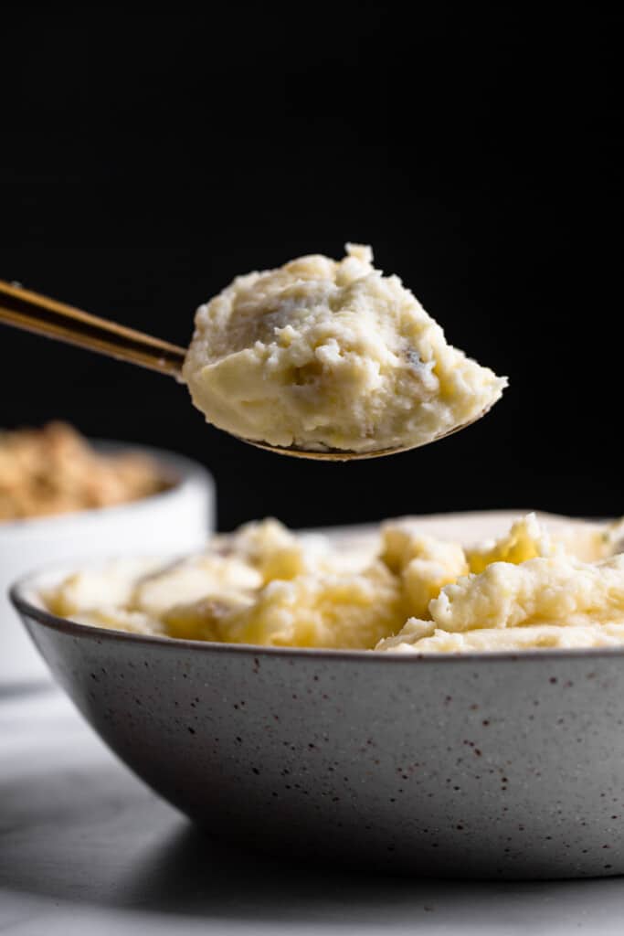 Healthy Mashed Potatoes being scooped out of a bowl