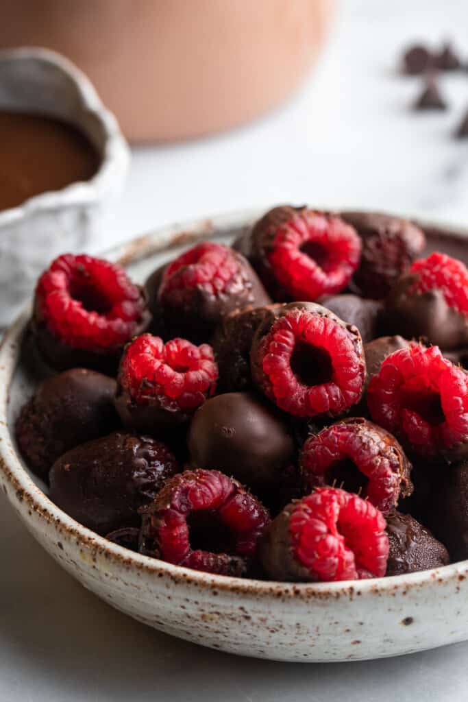a bowl full of Chocolate Covered Raspberries