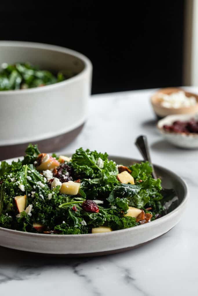 a plate of Kale Salad with Cranberries on a table