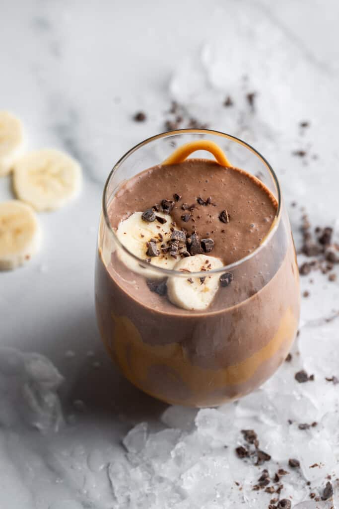 a glass filled with Chocolate Peanut Butter Banana Smoothie