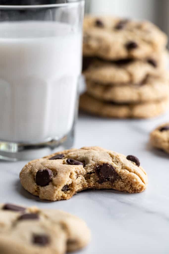 a glass of milk with a Gluten Free Chocolate Chip Cookie