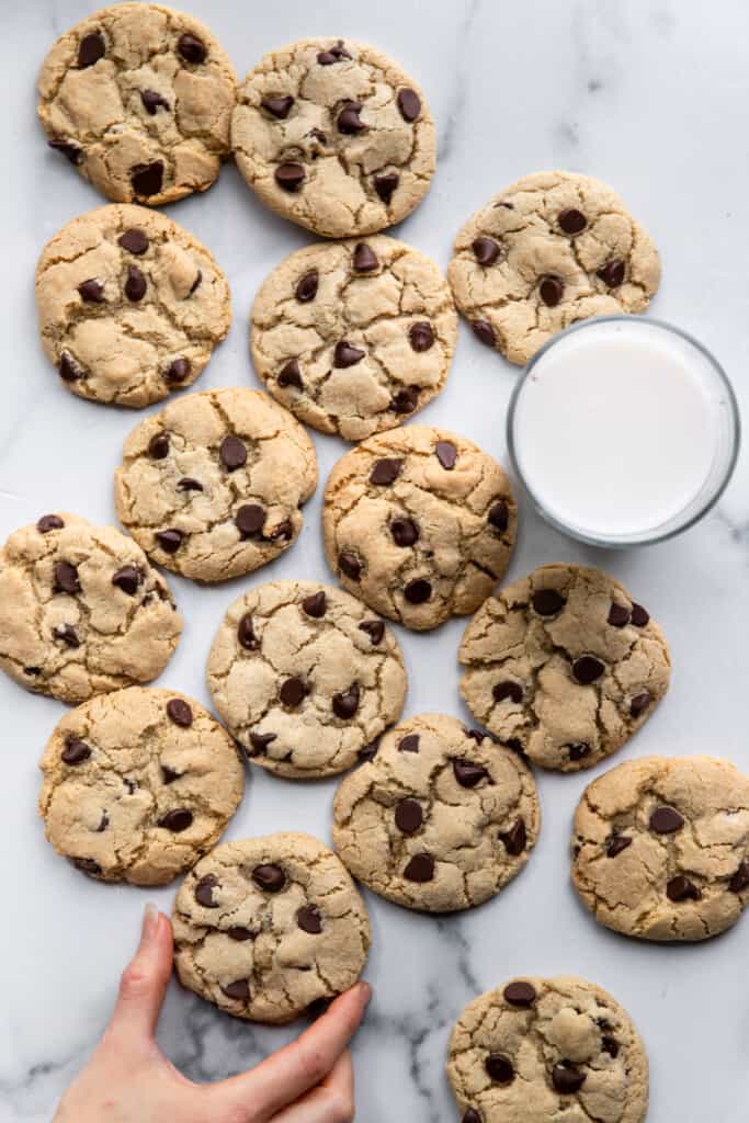 Gluten Free Chocolate Chip Cookies on a table with a glass of milk