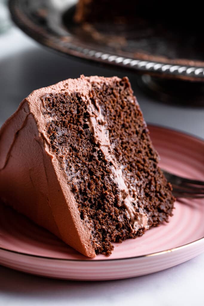 a slice of Healthy Chocolate Cake on a pink plate