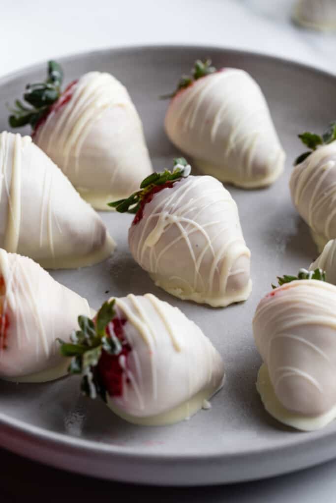 a serving plate covered in White Chocolate Covered Strawberries