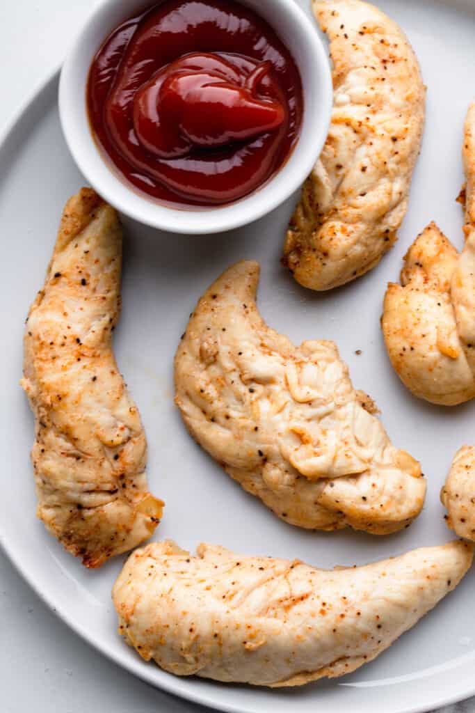 Air Fryer Chicken Tenders No Breading on a plate with sauce