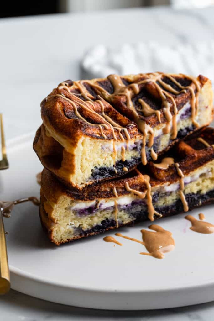 a stack of Blueberry Cheesecake Stuffed Protein Waffles on a plate