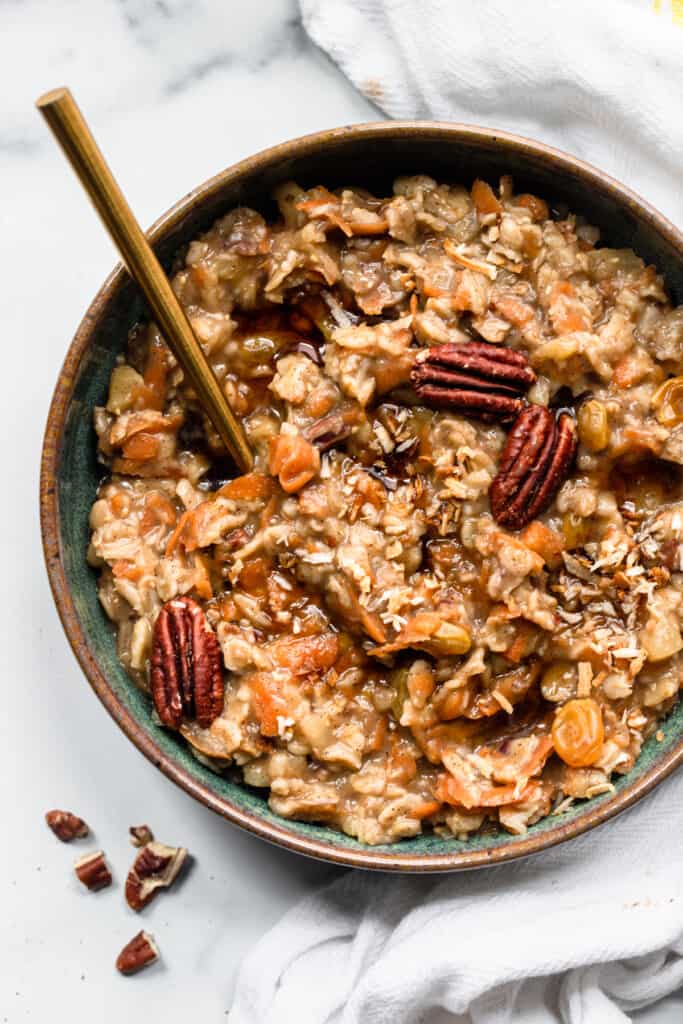 a bowl of Carrot Cake Oatmeal with pecans on top