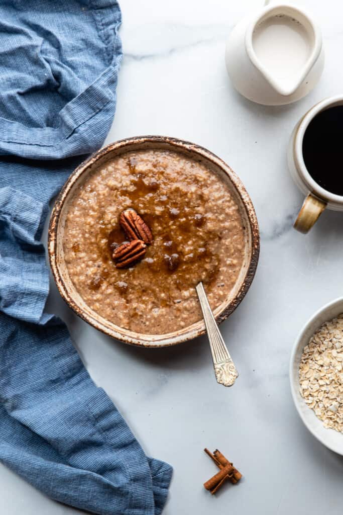 a bowl of Maple Brown Sugar Oatmeal on a table with coffee
