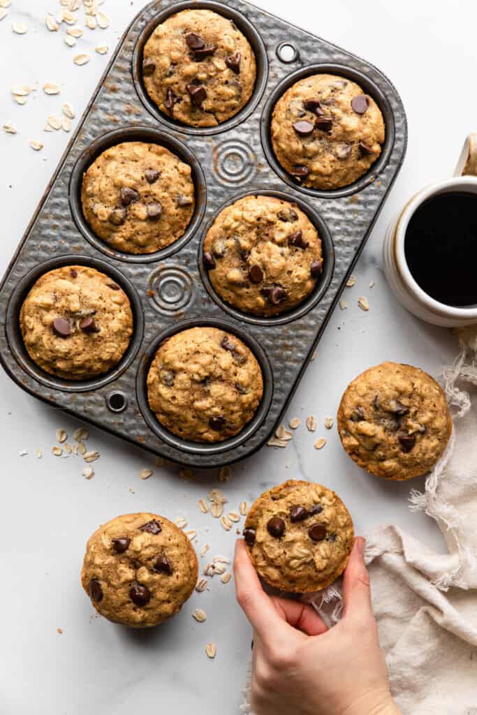 Oatmeal Chocolate Chip Muffins on a table with coffee