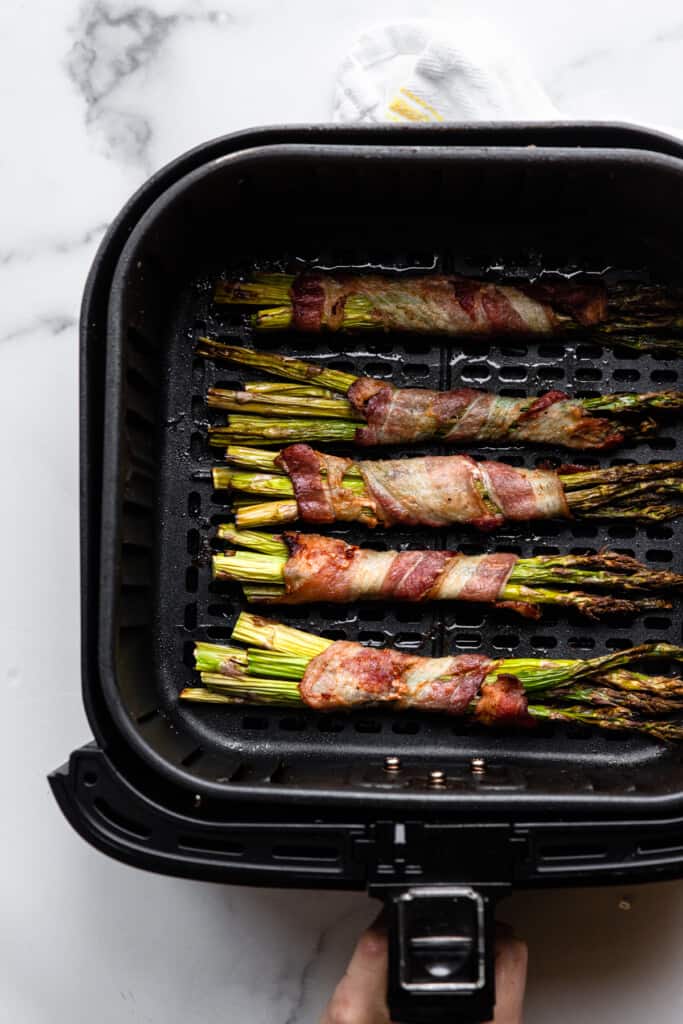 Air Fryer Bacon Wrapped Asparagus in an air fryer