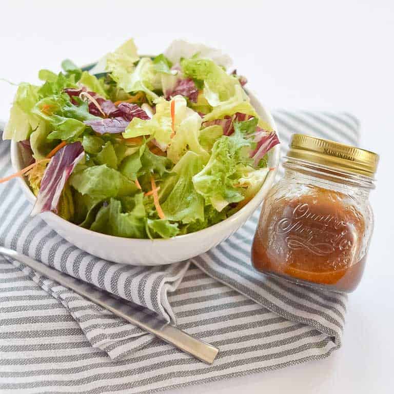 Salad with jar of dressing