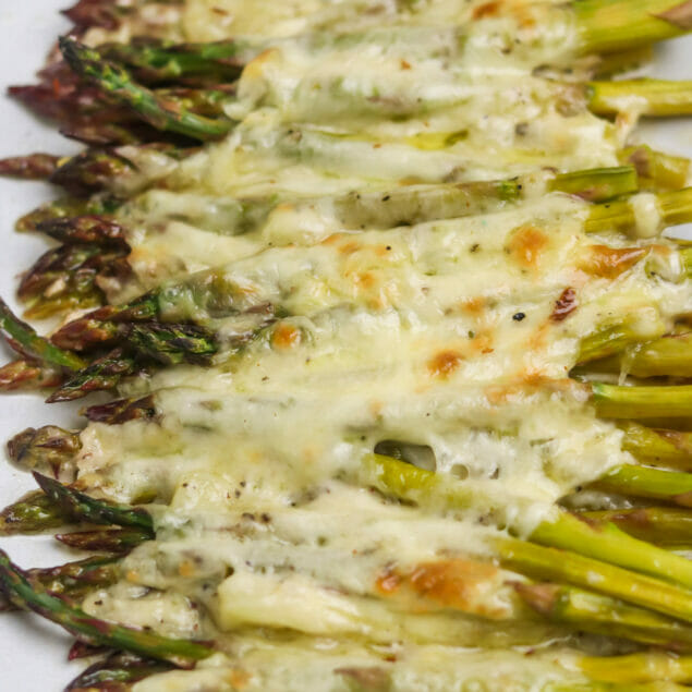 Cheesy baked asparagus close-up