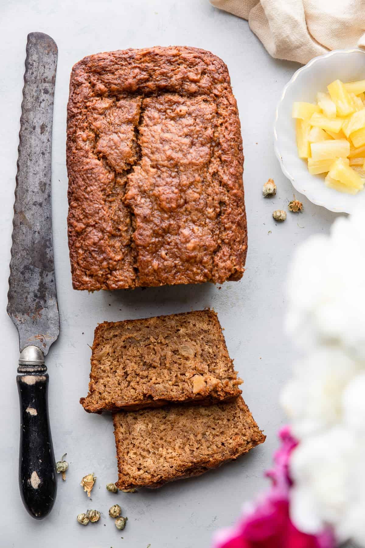 one loaf of Banana Pineapple Bread with a knife on the side